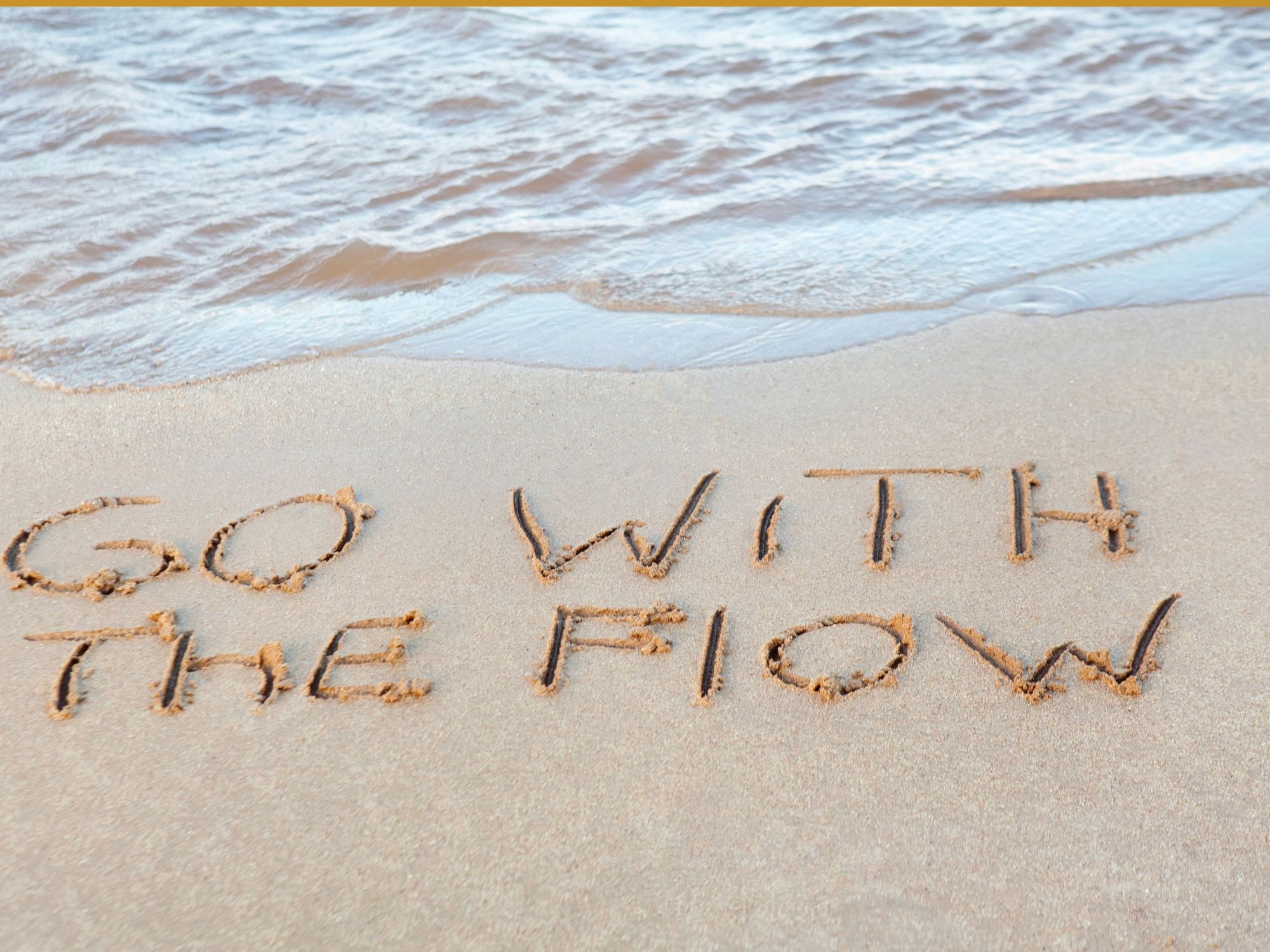 Go with the Flow written in sand View more by JodiJacobson from Getty Images Signature