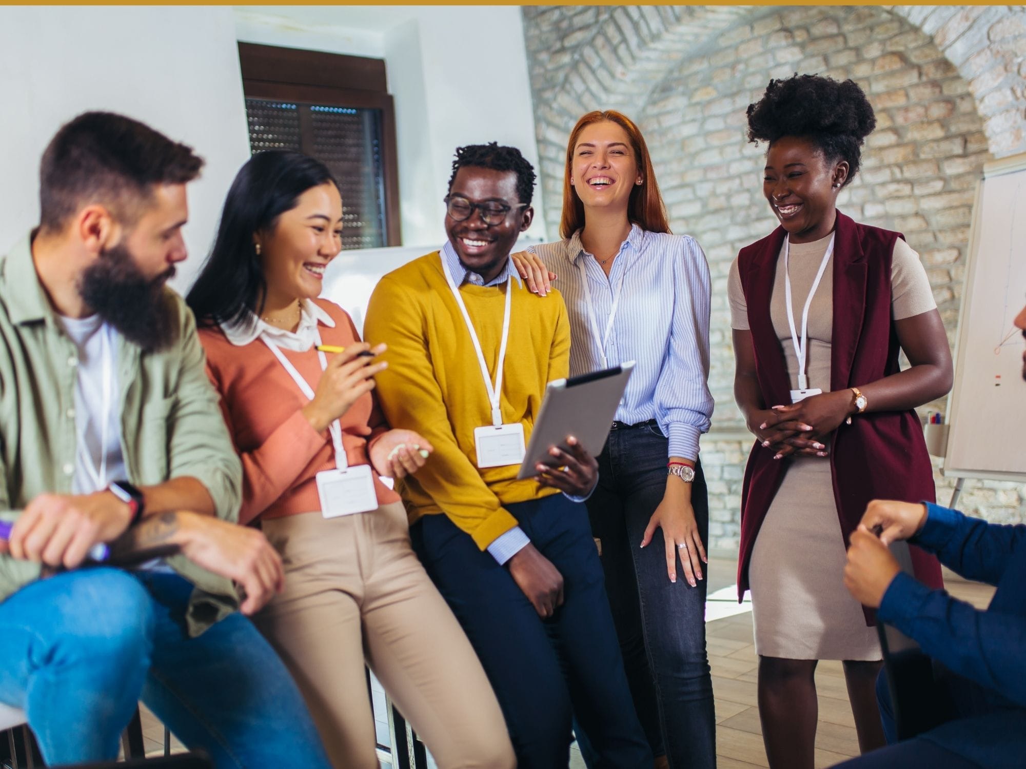 Happy business team at corporate training, team building activity, diverse employees group. by Jovanmandic from Getty Images